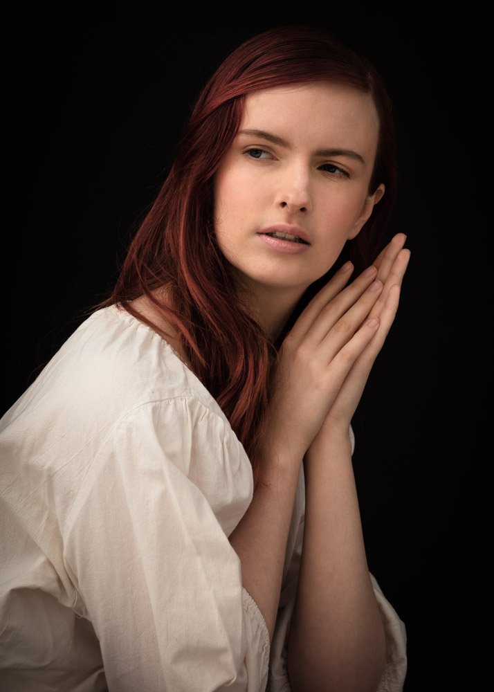 renaissance style portrait of a woman with long red hair