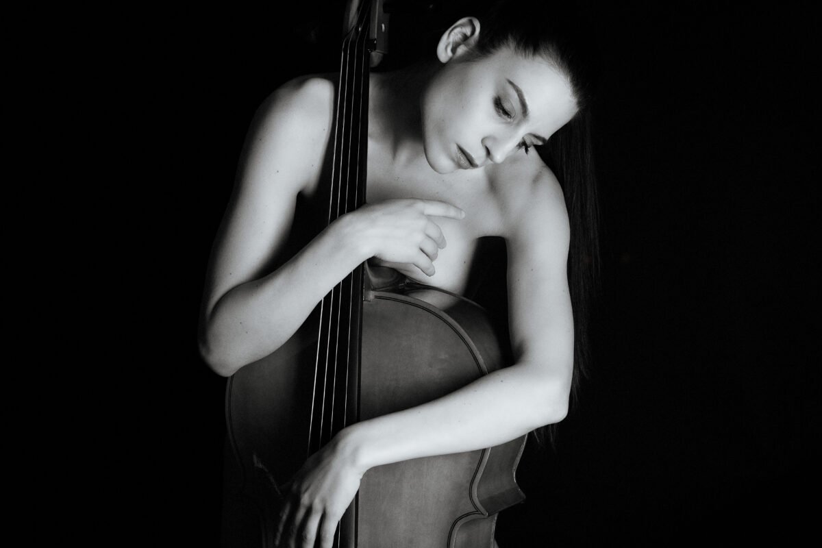 Black and white portrait of a musician with a cello