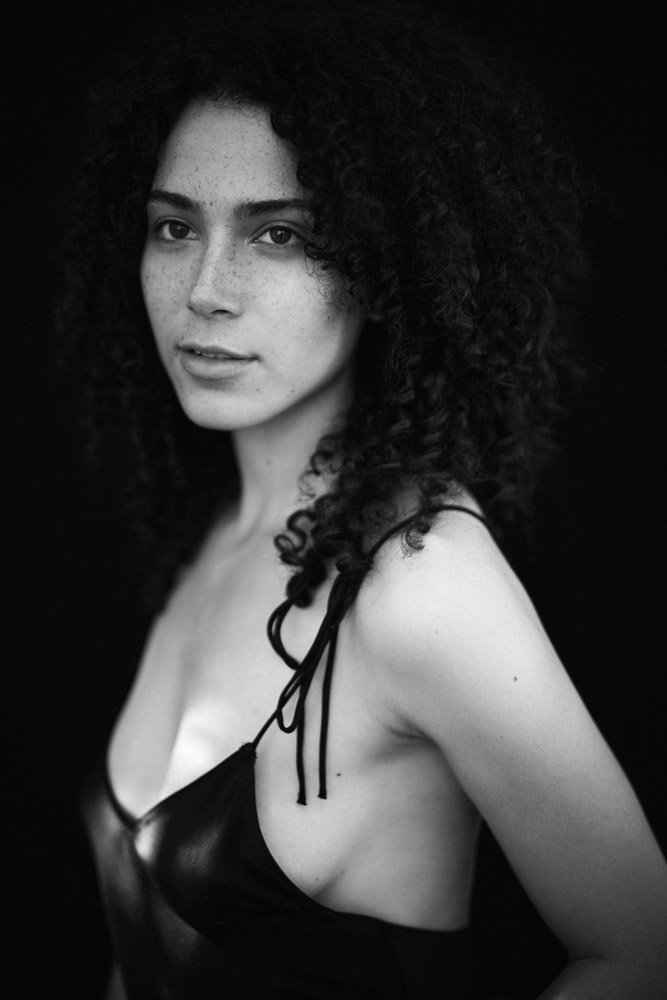 black and wihite portrait of a woman with black curly hair