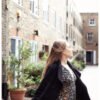 Fine art photograph of a woman dancing freely in a London mews, capturing an ethereal, joyful moment in the city.